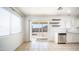 Bright eating area featuring a view to backyard, open shelves, tile floor and stainless dishwasher at 2803 W Angela Dr, Phoenix, AZ 85053