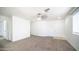 Inviting living room features plush carpeting, a ceiling fan, and ample natural light at 2803 W Angela Dr, Phoenix, AZ 85053