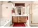 Bathroom featuring double sink vanity, separate bathtub, and glass door shower at 3055 N Red Mtn # 178, Mesa, AZ 85207