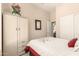 Bedroom with light colored wardrobe, floral arrangement and decorative mirror at 3055 N Red Mtn # 178, Mesa, AZ 85207