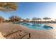 Community pool with lounge chairs and covered seating areas, perfect for relaxation at 3055 N Red Mtn # 178, Mesa, AZ 85207