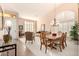 Bright living room with plantation shutters, a modern chandelier, and neutral decor at 3055 N Red Mtn # 178, Mesa, AZ 85207