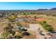 Aerial view showcases community park with tennis courts, basketball court, and desert surroundings at 3129 W Walter Way, Phoenix, AZ 85027