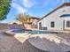 Backyard featuring a private pool, rock landscaping, and the exterior of the house with neutral paint at 3129 W Walter Way, Phoenix, AZ 85027