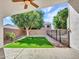 Inviting backyard featuring a covered patio, artificial grass, and a well-maintained landscape at 3129 W Walter Way, Phoenix, AZ 85027