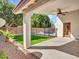 Covered patio overlooking a fenced backyard with lush artificial grass and a pool in the distance at 3129 W Walter Way, Phoenix, AZ 85027