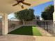 Beautiful backyard with artificial grass, trees, and manicured landscaping at 3129 W Walter Way, Phoenix, AZ 85027