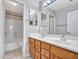 Bright bathroom featuring double sinks, wood cabinets, and a shower-tub combination at 3129 W Walter Way, Phoenix, AZ 85027