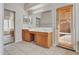 Bathroom featuring double sinks, tile floor, and access to outdoor patio at 3129 W Walter Way, Phoenix, AZ 85027