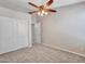 Comfortable carpeted bedroom with a ceiling fan and a closet for storage at 3129 W Walter Way, Phoenix, AZ 85027