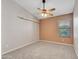 Neutral carpeted bedroom featuring a window for natural light and a ceiling fan at 3129 W Walter Way, Phoenix, AZ 85027