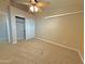 Cozy bedroom featuring a ceiling fan and closet with sliding doors at 3129 W Walter Way, Phoenix, AZ 85027