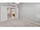 Bright bedroom featuring a door to a bathroom and neutral walls and carpet at 3129 W Walter Way, Phoenix, AZ 85027