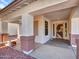 Charming covered front porch with stone pillars and a decorative front door at 3129 W Walter Way, Phoenix, AZ 85027