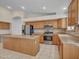 Bright kitchen features stainless steel appliances, wood cabinets, and a large center island at 3129 W Walter Way, Phoenix, AZ 85027