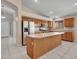 An open-concept kitchen featuring stainless steel appliances, wood cabinets and an island at 3129 W Walter Way, Phoenix, AZ 85027