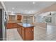 Bright kitchen featuring wood cabinets, stainless steel appliances, tile flooring and a center island at 3129 W Walter Way, Phoenix, AZ 85027