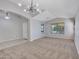 Bright living room with carpet, large windows, and a modern light fixture at 3129 W Walter Way, Phoenix, AZ 85027