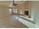 Sunlit living room features tile flooring, fireplace, and backyard access at 3129 W Walter Way, Phoenix, AZ 85027