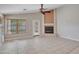 Spacious living room featuring a fireplace and ample natural light through a large window at 3129 W Walter Way, Phoenix, AZ 85027