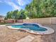 Private backyard pool is surrounded by desert landscaping and mature trees, perfect for outdoor relaxation at 3129 W Walter Way, Phoenix, AZ 85027