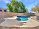 Private backyard pool featuring a unique shape, surrounded by a concrete patio and rock landscaping at 3129 W Walter Way, Phoenix, AZ 85027