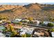 Aerial view of homes with desert mountain views and lush, green landscaping at 3348 E Eva St, Phoenix, AZ 85028