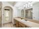 Well-lit bathroom featuring a large mirror, tile countertop, and glass shower at 3348 E Eva St, Phoenix, AZ 85028