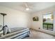 Bright bedroom with a cozy daybed, ceiling fan, and a window view at 3348 E Eva St, Phoenix, AZ 85028