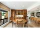 Bright dining area with wood table, built-in cabinets, and an adjacent open-concept kitchen at 3348 E Eva St, Phoenix, AZ 85028