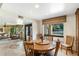 Bright dining area with view to living room and front yard, featuring a wood table and chairs at 3348 E Eva St, Phoenix, AZ 85028