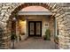 Close up of front door with decorative wrought iron doors and stone archway at 3348 E Eva St, Phoenix, AZ 85028