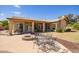 Beautiful backyard with covered patio, custom fire pit, and patio table adjacent to lush lawn at 3350 W Ivanhoe Ct, Chandler, AZ 85226