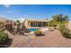 Expansive backyard featuring a custom pool with waterfall, a seating area, and mature landscaping at 3350 W Ivanhoe Ct, Chandler, AZ 85226