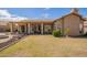 Backyard featuring outdoor kitchen, covered patio, outdoor seating, and a large grassy area at 3350 W Ivanhoe Ct, Chandler, AZ 85226