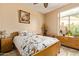 Cozy bedroom featuring a comfortable bed, bedside table, and dresser near a window at 3350 W Ivanhoe Ct, Chandler, AZ 85226