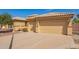 View of the attractive two-car garage and well-maintained landscaping that enhances this home's curb appeal at 3350 W Ivanhoe Ct, Chandler, AZ 85226