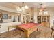 Game room showcasing a pool table, neutral decor, and open architecture for seamless entertainment and relaxation at 3350 W Ivanhoe Ct, Chandler, AZ 85226