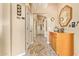 Spacious hallway featuring unique tile flooring, neutral walls, and a built-in cabinet and decorative mirror at 3350 W Ivanhoe Ct, Chandler, AZ 85226