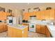 Well-lit kitchen boasting ample counter space, modern appliances, and a functional island for meal preparation at 3350 W Ivanhoe Ct, Chandler, AZ 85226