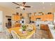 Bright kitchen features light wood cabinetry, a central island, and a cozy dining area, perfect for Gathering meals and gatherings at 3350 W Ivanhoe Ct, Chandler, AZ 85226