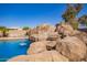 Close up of the rock waterfall with slide feature flowing into the refreshing pool at 3350 W Ivanhoe Ct, Chandler, AZ 85226