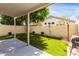 This beautiful backyard features green turf, a covered patio, and a brick wall at 3435 E Renee Dr, Phoenix, AZ 85050