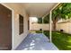 Relaxing covered backyard patio with modern concrete flooring and view of the landscaped yard at 3435 E Renee Dr, Phoenix, AZ 85050