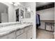 Bathroom vanity with granite countertops, double mirrors and entrance to walk in closet at 3435 E Renee Dr, Phoenix, AZ 85050