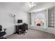 This bedroom offers an arched window, built in shelves, and a ceiling fan at 3435 E Renee Dr, Phoenix, AZ 85050