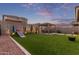 Lush backyard featuring well-manicured artificial turf, a gazebo, and a playset at 3483 W Verde River Rd, San Tan Valley, AZ 85144