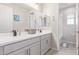 Bathroom featuring double sinks, light grey cabinets, modern fixtures, and a view into the shower at 3483 W Verde River Rd, San Tan Valley, AZ 85144