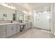 Bright bathroom with dual vanities, walk-in shower with frameless glass, and tile floors at 3483 W Verde River Rd, San Tan Valley, AZ 85144