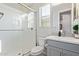 Bright bathroom featuring a glass enclosed shower, toilet, and vanity with a sink and large mirror at 3483 W Verde River Rd, San Tan Valley, AZ 85144